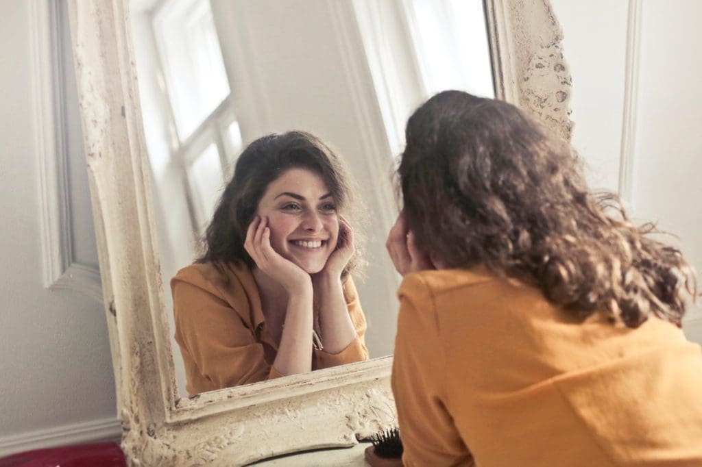 photo of woman looking at the mirror 774866